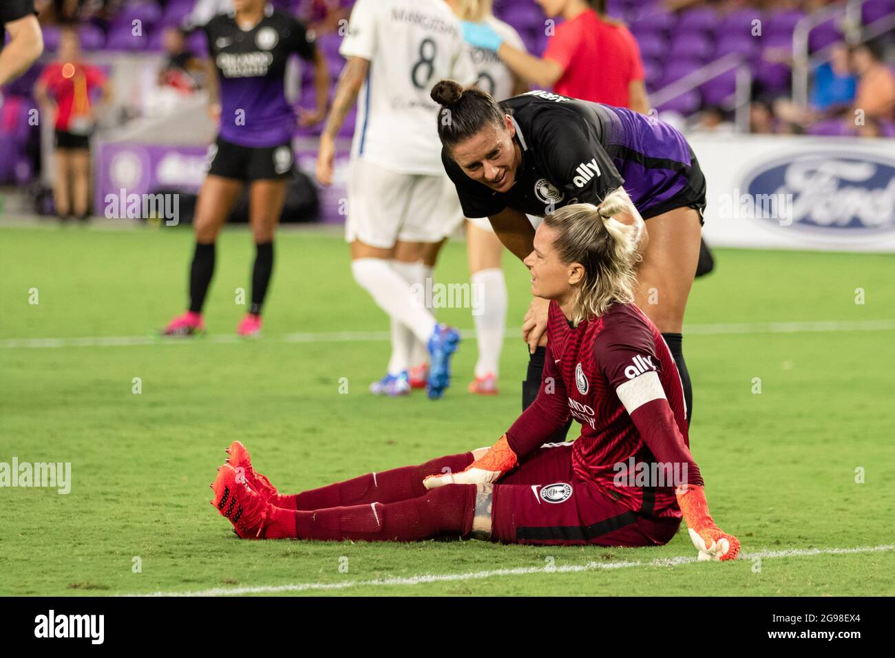 Orlando, United States. 25th July, 2021. Ali Krieger (11 Orlando Pride)  checks on Ashlyn Harris (24 Orlando Pride) after taking a hit on the knee  during the National Women's Soccer League game