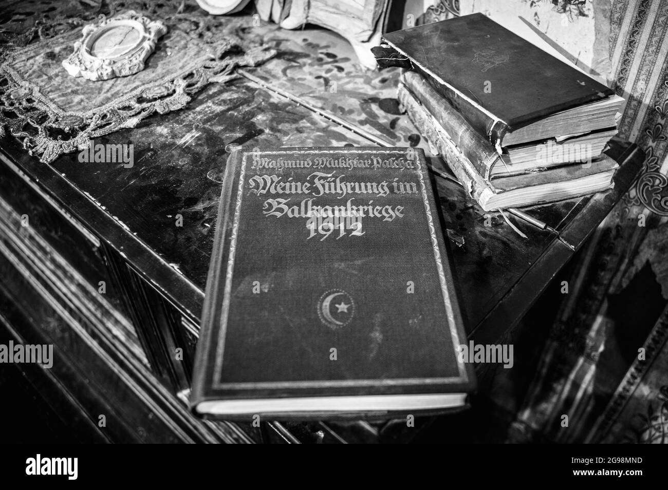 Ancient books on top of the dusty cupboard in the city of Moscow, Russia. Black and white. Stock Photo