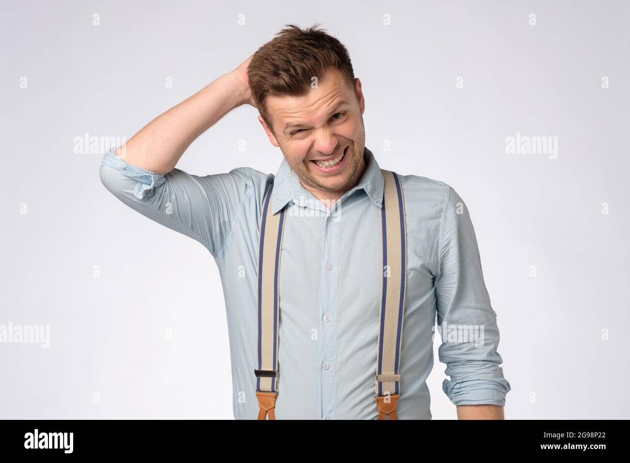 young caucasian man scratching his head, making a hard decision, Stock Photo