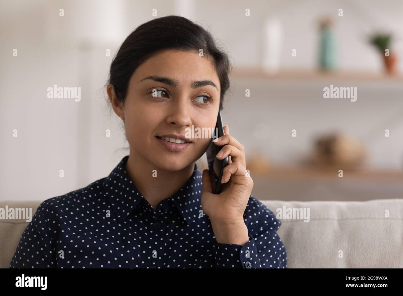 Head shot smiling Indian woman talking on phone at home Stock Photo - Alamy