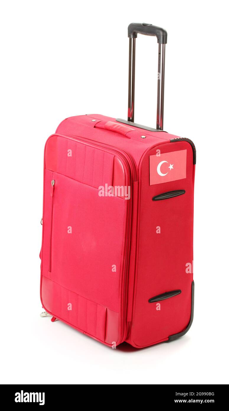 red suitcase with sticker with flag of 