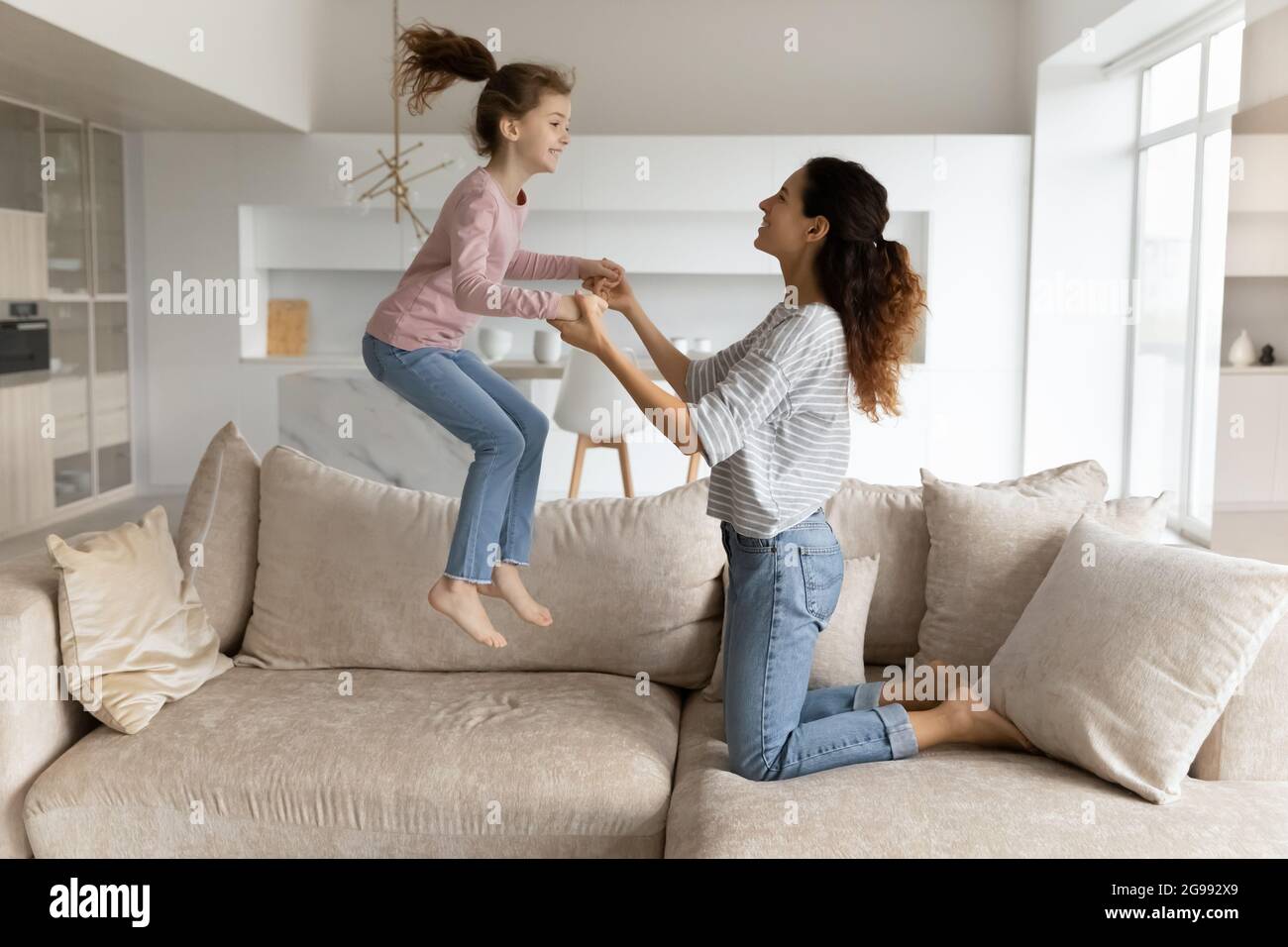 Happy Latin mother and teen daughter have fun at home Stock Photo - Alamy