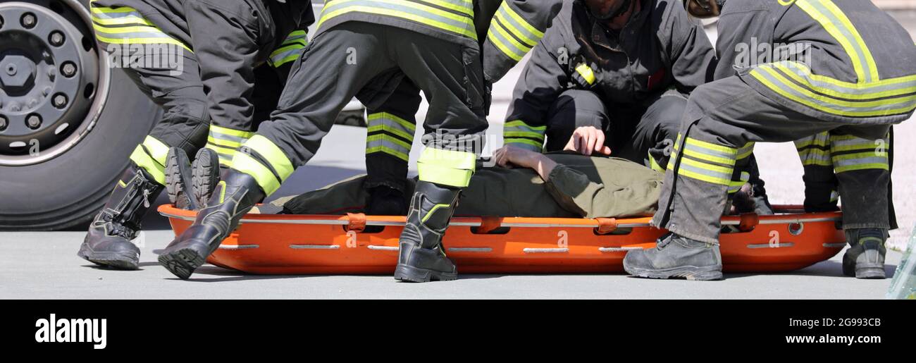 brave rescuers recover the injured with a special orange stretcher to ...