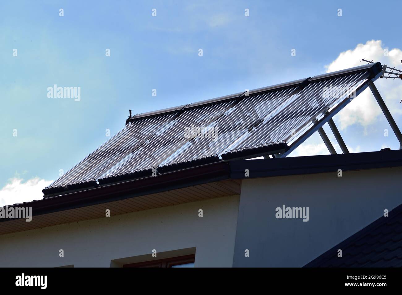 Solar panels for heating domestic hot water on the roof of the house. Summer Stock Photo