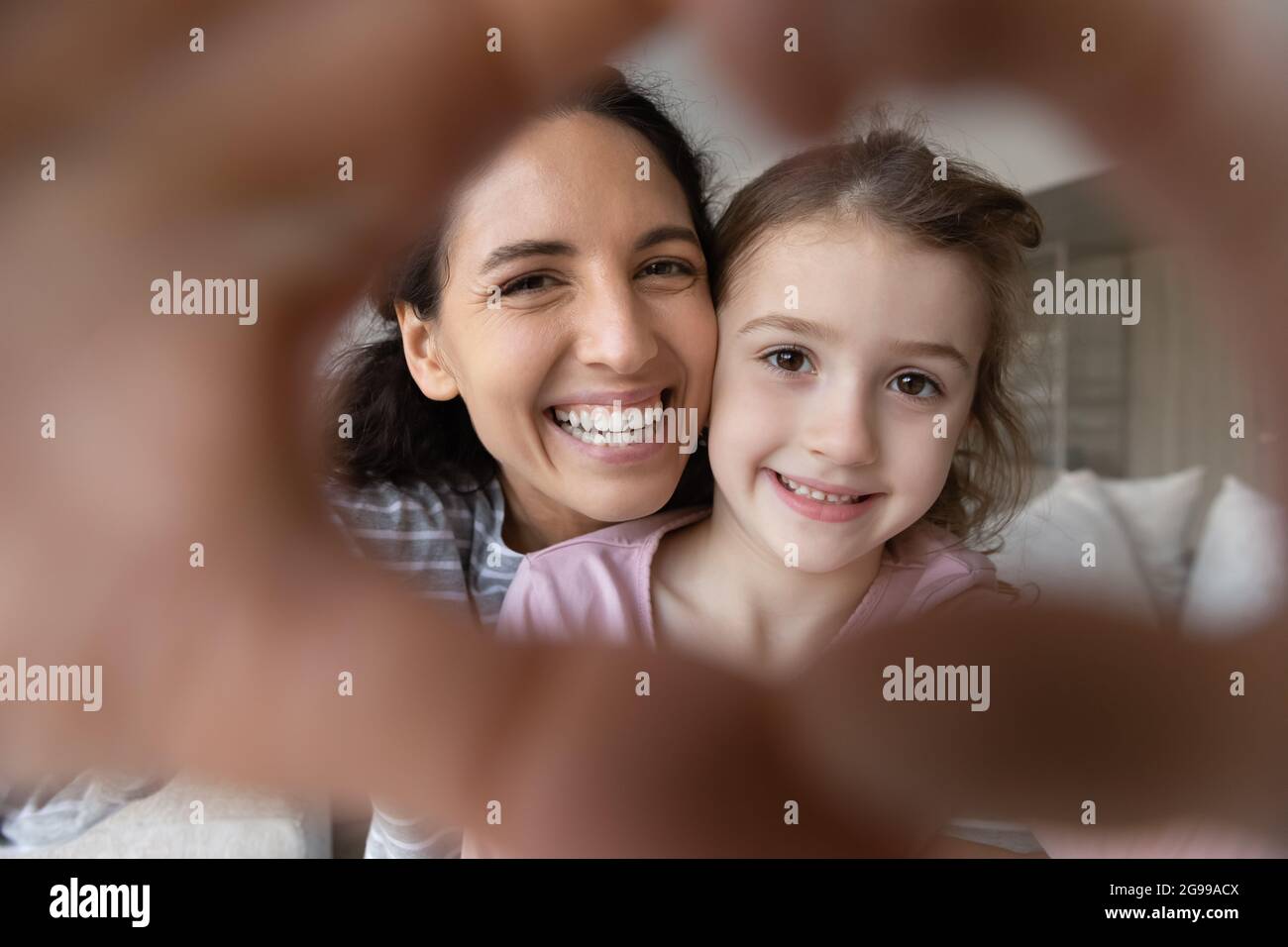 Portrait of happy Latin mom and daughter make selfie Stock Photo - Alamy