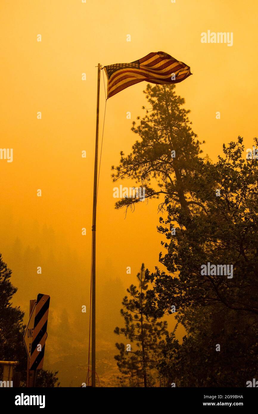 California, United States. 24th July, 2021. The American flag blows in the wind at the Dixie fire. The Dixie fire continues to burn in California burning over 180,000 acres with 20% containment. Credit: SOPA Images Limited/Alamy Live News Stock Photo