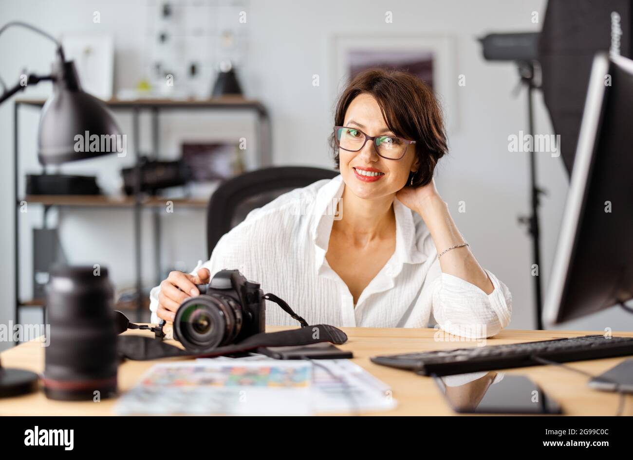 Female photographer at office Stock Photo