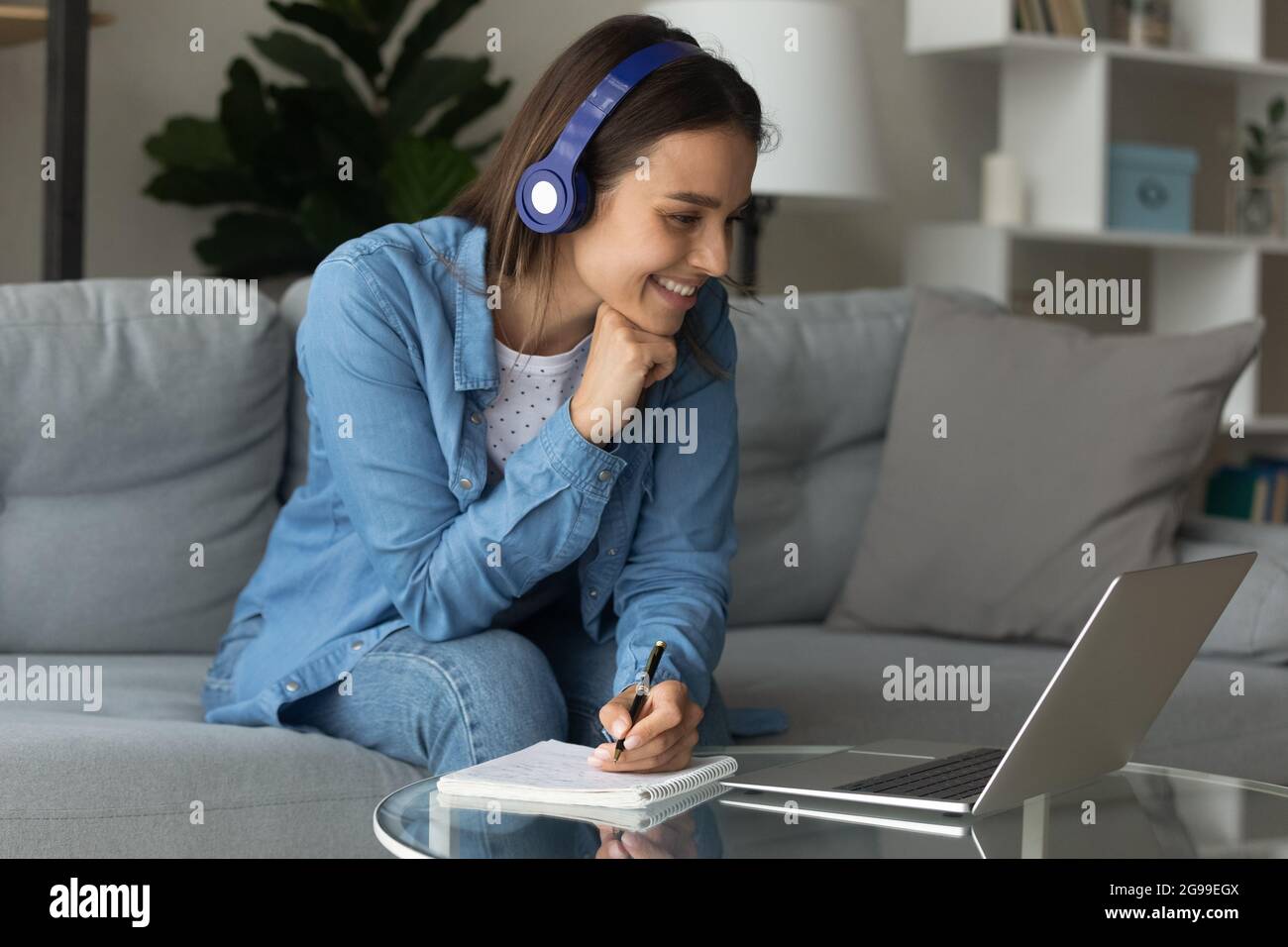 Woman e-learn use laptop listen audio course through wireless ...