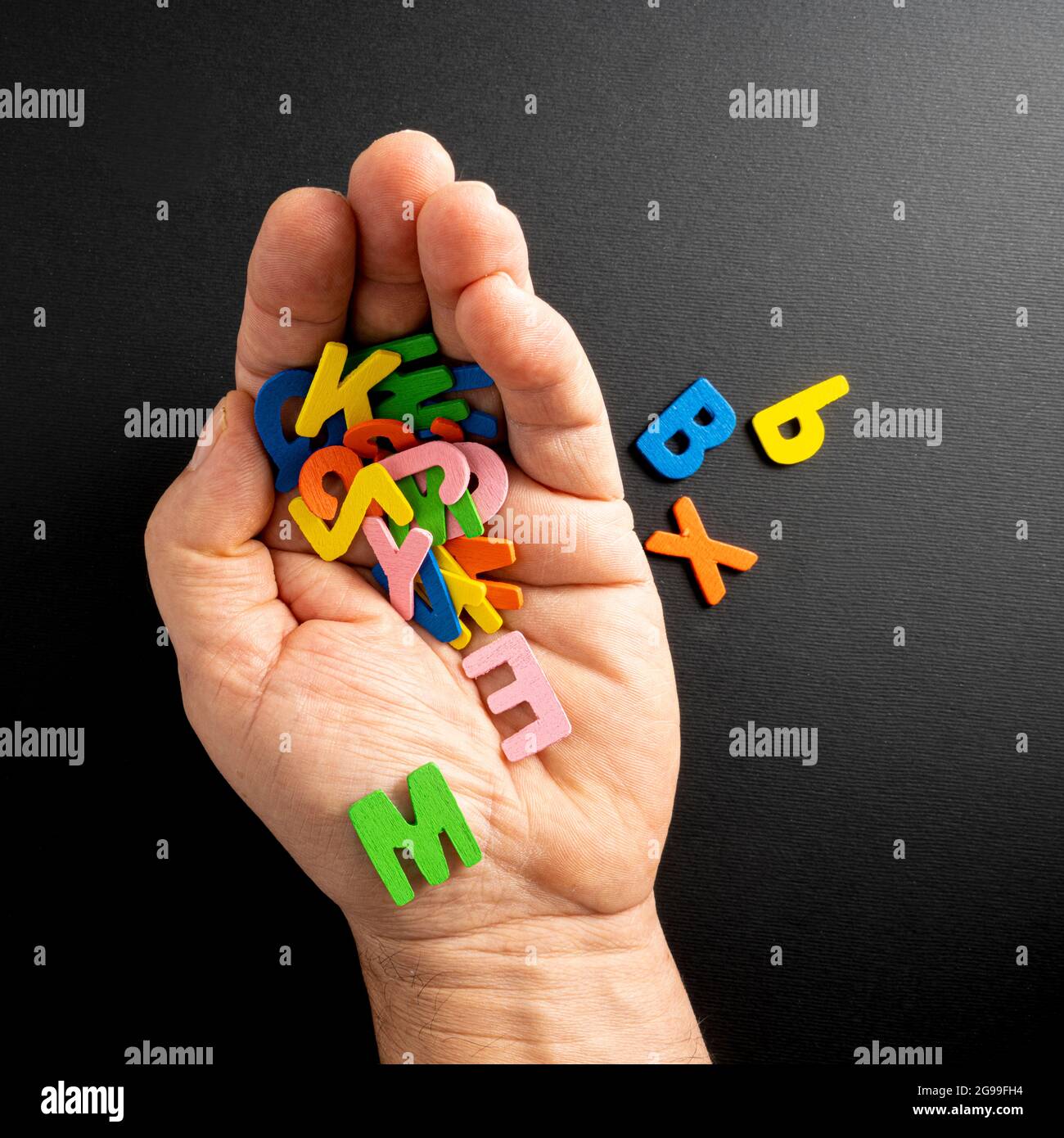 some colored letters in the palm of the hand Stock Photo