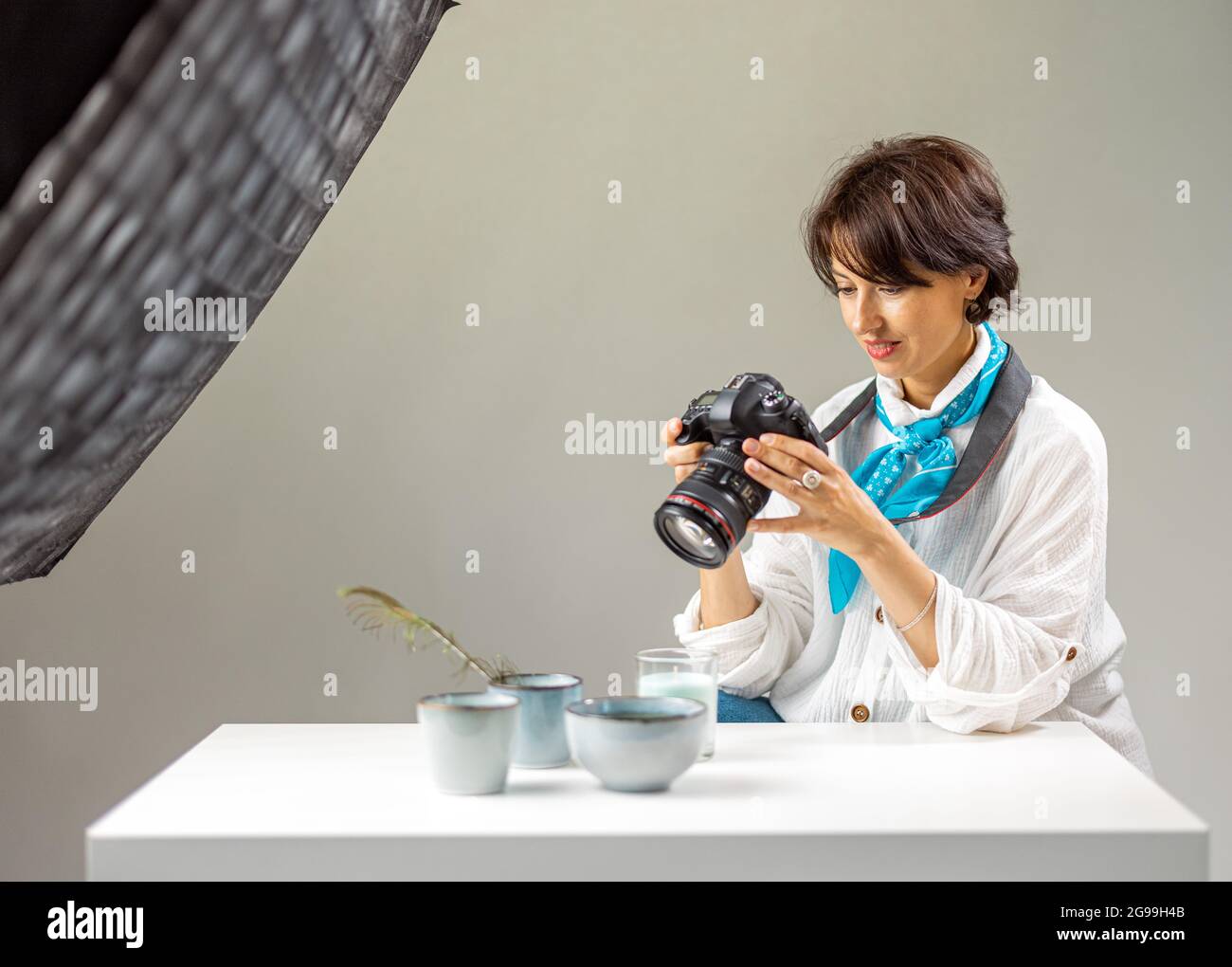 Woman reviewing pictures on camera Stock Photo