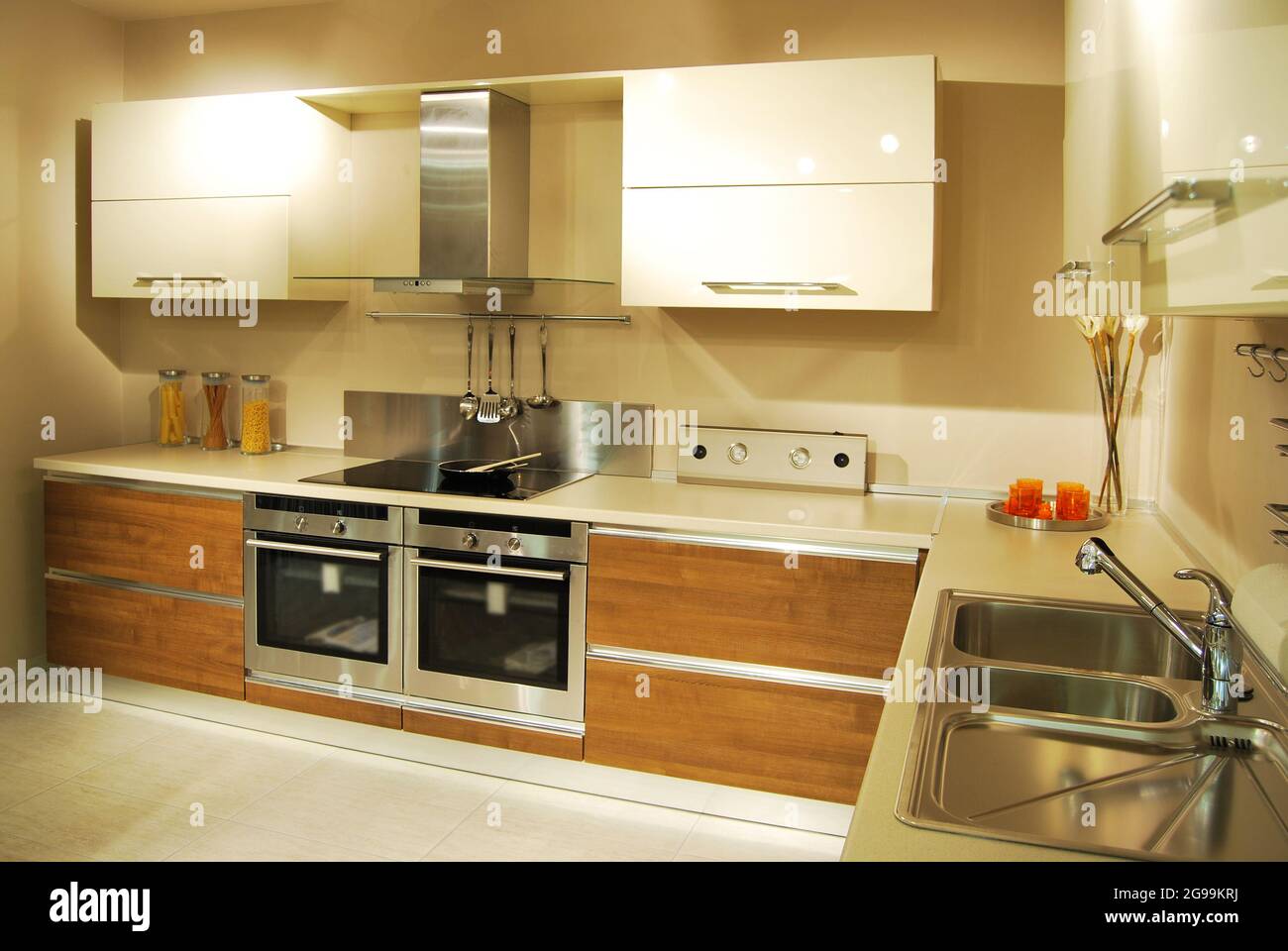 Interior of luxurious modern kitchen equipment, white and walnut