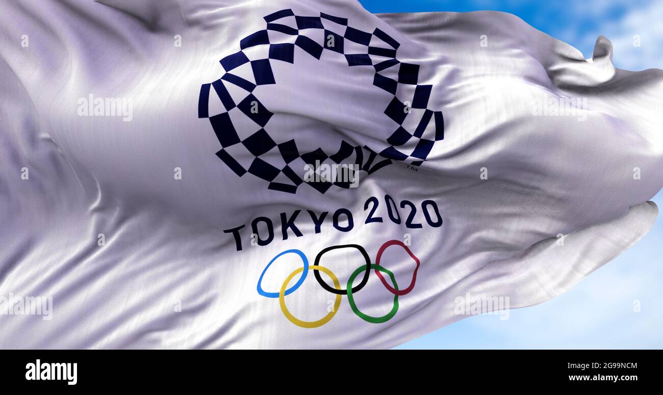 Tokyo, Japan, July 2021: Tokyo 2020 olympic flag waving in the wind. Tokyo 2020 olympics games were postponed to 2021 due to the covid-19 pandemic Stock Photo