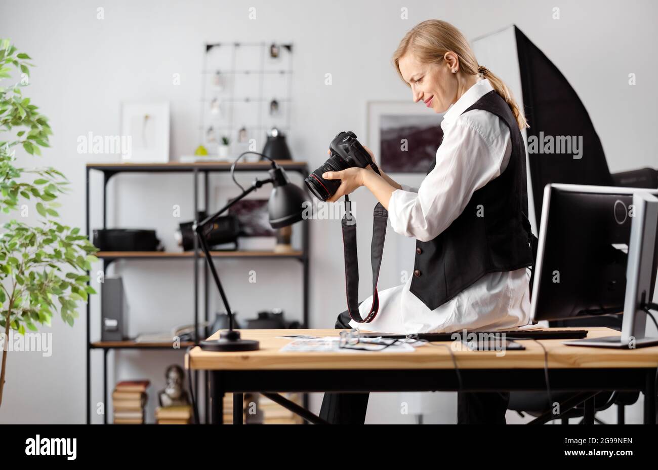 Photographer with camera at office Stock Photo
