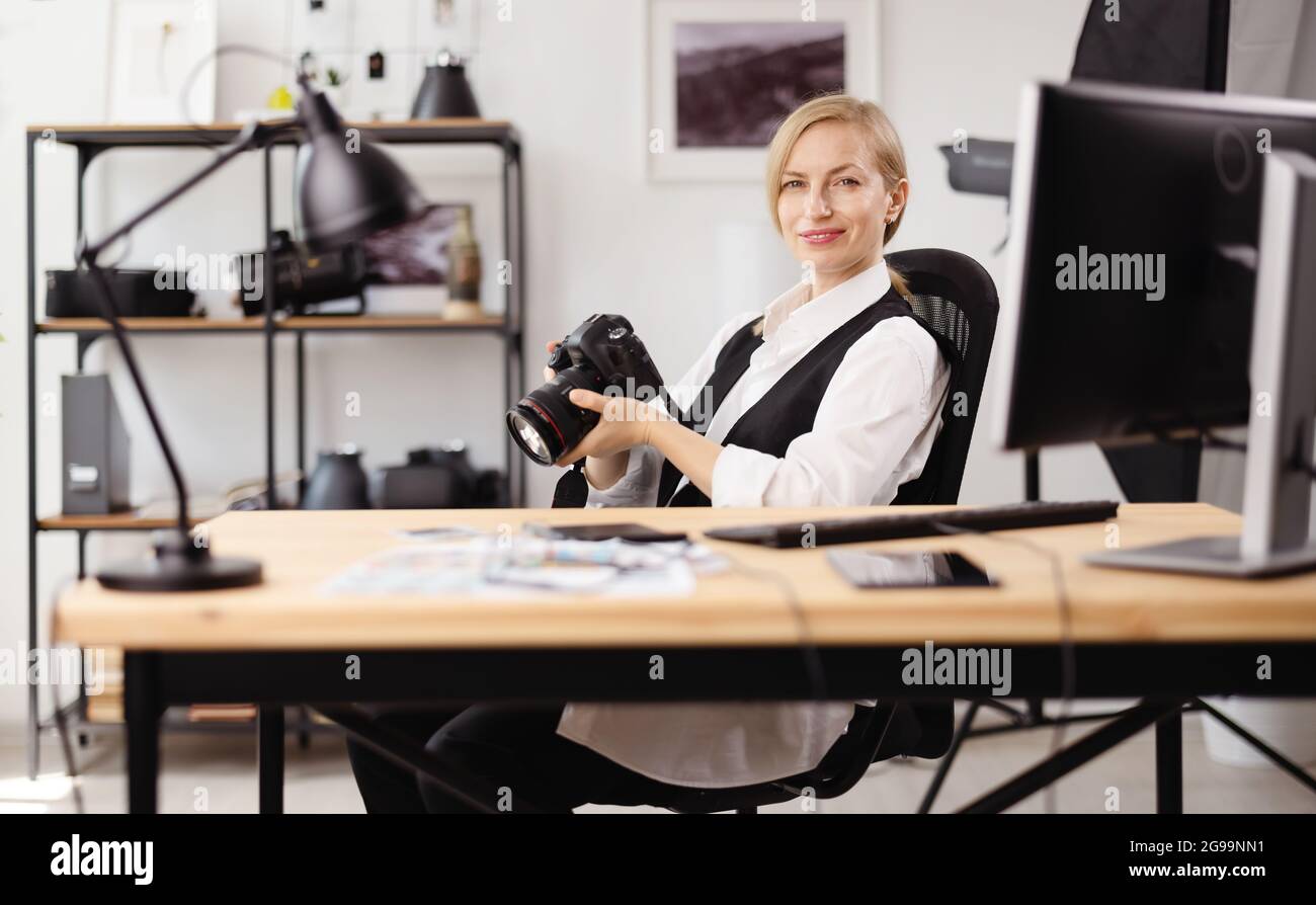 Photographer sitting at office Stock Photo