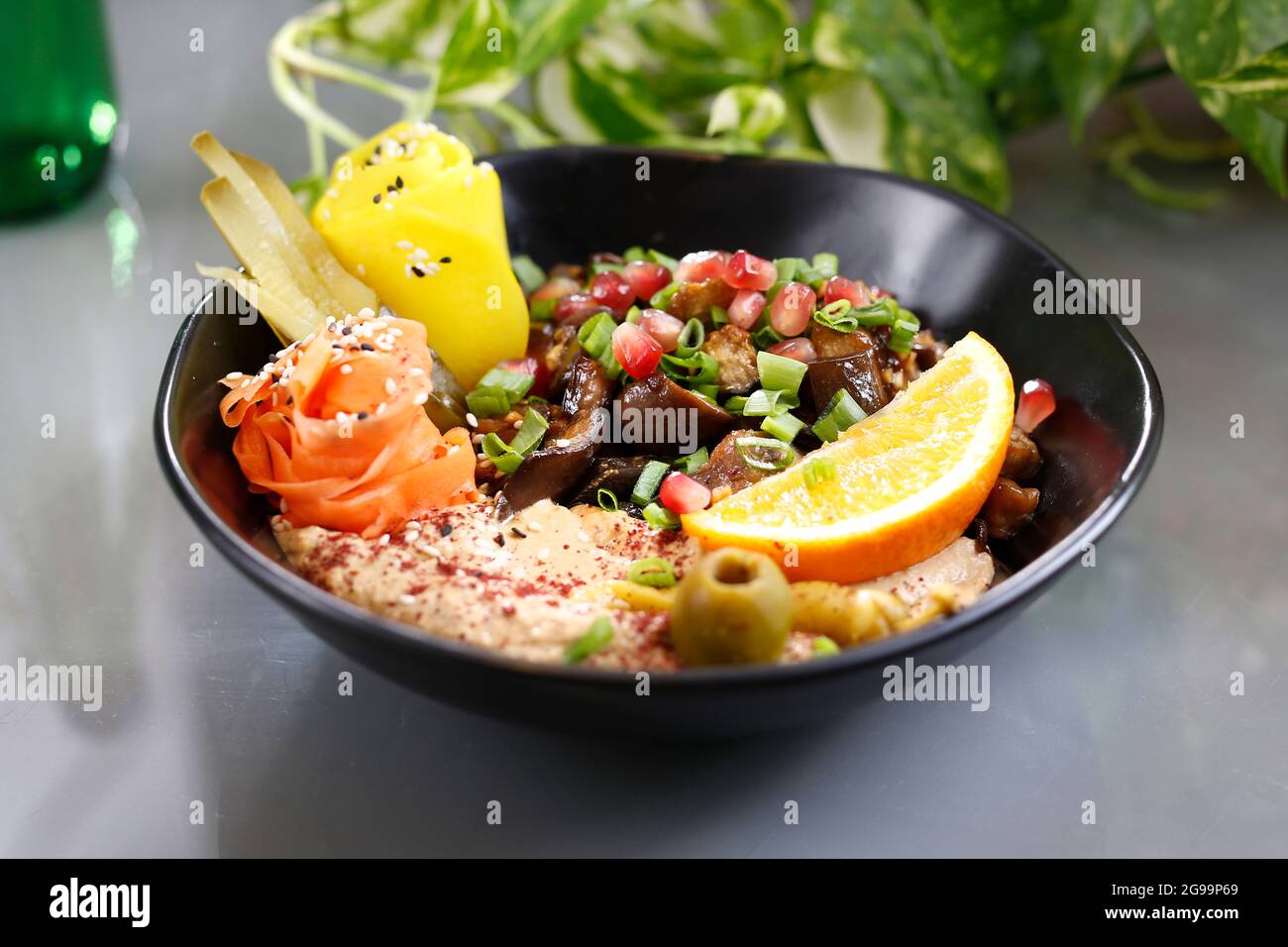 Humus with a patch of mushrooms and vegetables. Vegetarian dish, food photography, serving proposal. Stock Photo