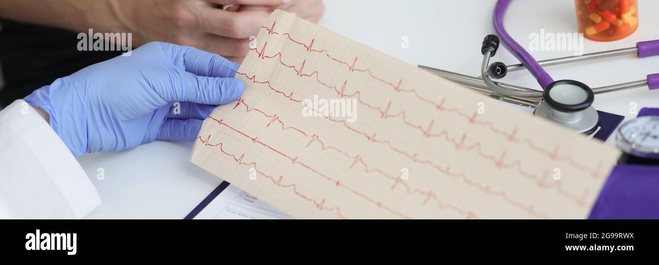 Doctor holds transcript of patient cardiogram in his hands Stock Photo ...
