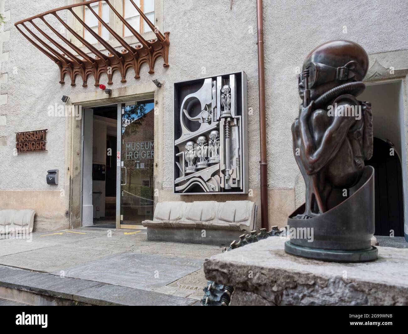 Sculpture of 'Birth Machine Baby' in front of the entrance to the H. R. Giger museum at Gruyere, Switzerland Stock Photo