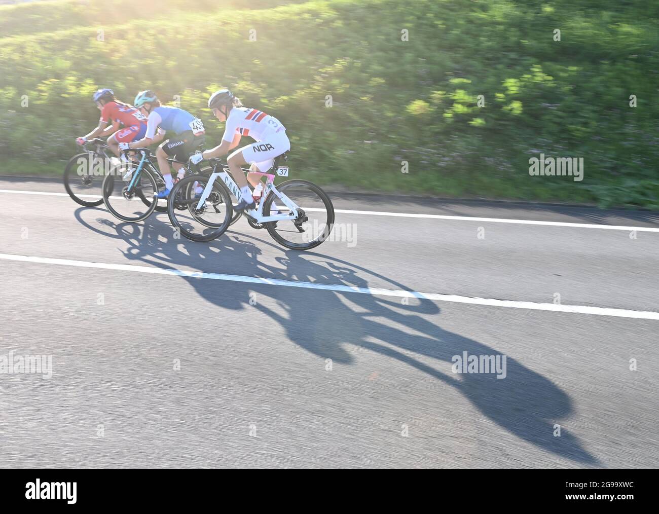 Shizuoka, Japan. 25th July, 2021. Riders compete during the women's cycling road race at the Tokyo 2020 Olympic Games in Shizuoka, Japan, July 25, 2021. Credit: He Changshan/Xinhua/Alamy Live News Stock Photo