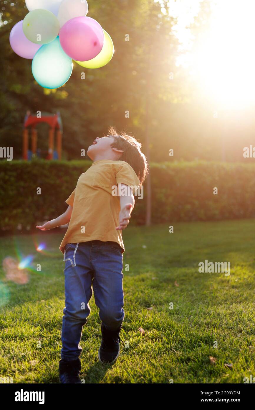 child in the park playing with balloons Stock Photo