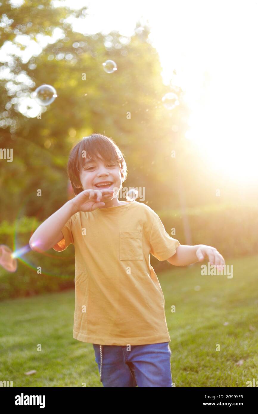 hispanic child playing in the park at sunset Stock Photo