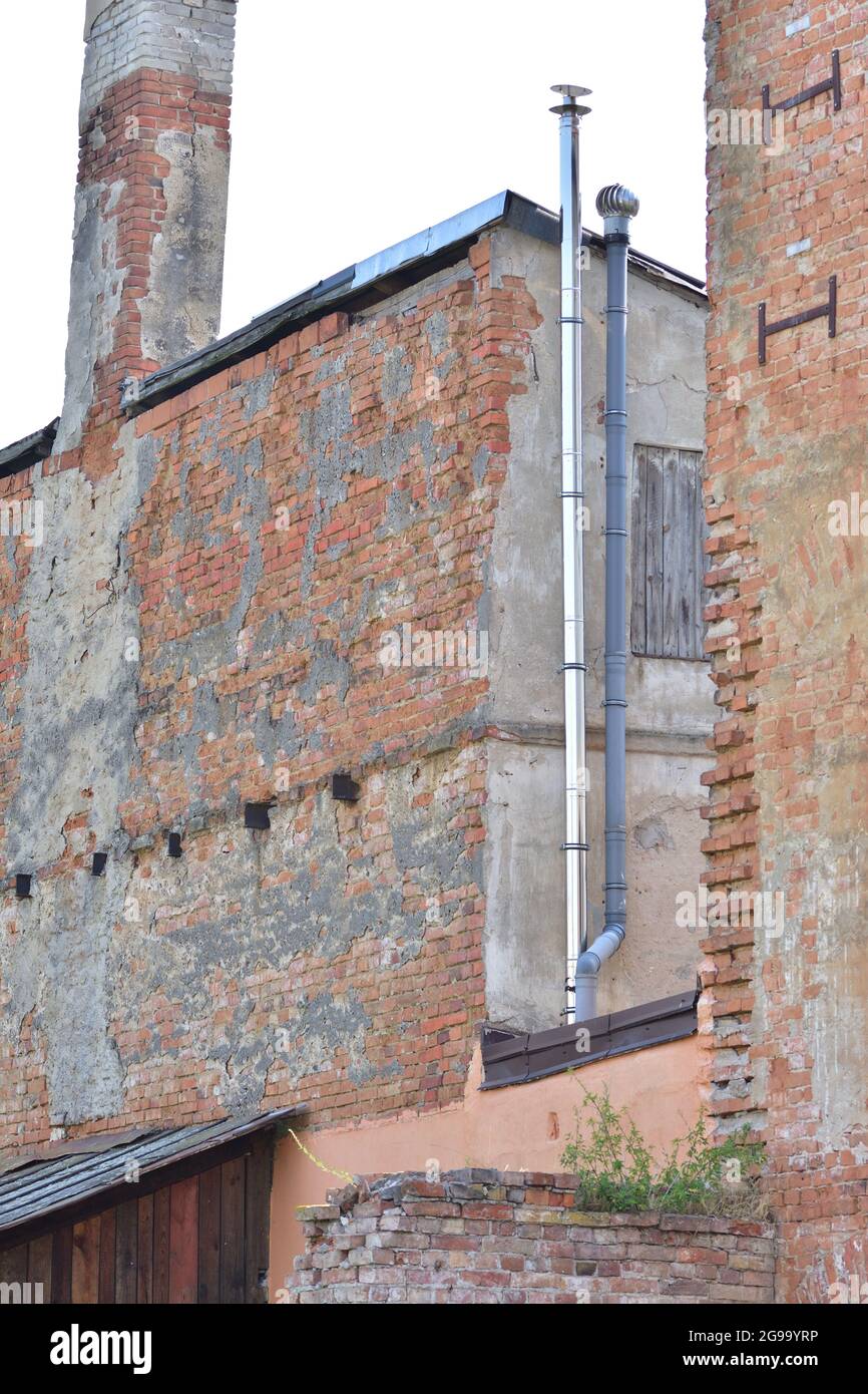 The old, neglected building is decaying in the city. Summer. Stock Photo