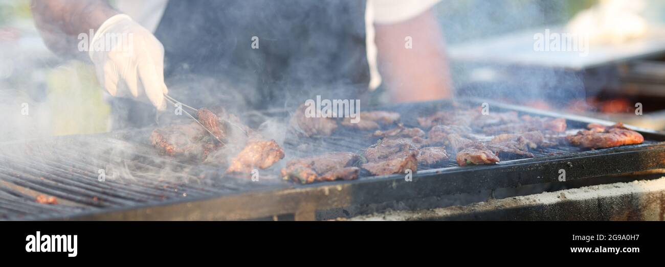 Cook turns meat on grill hi-res stock photography and images - Alamy