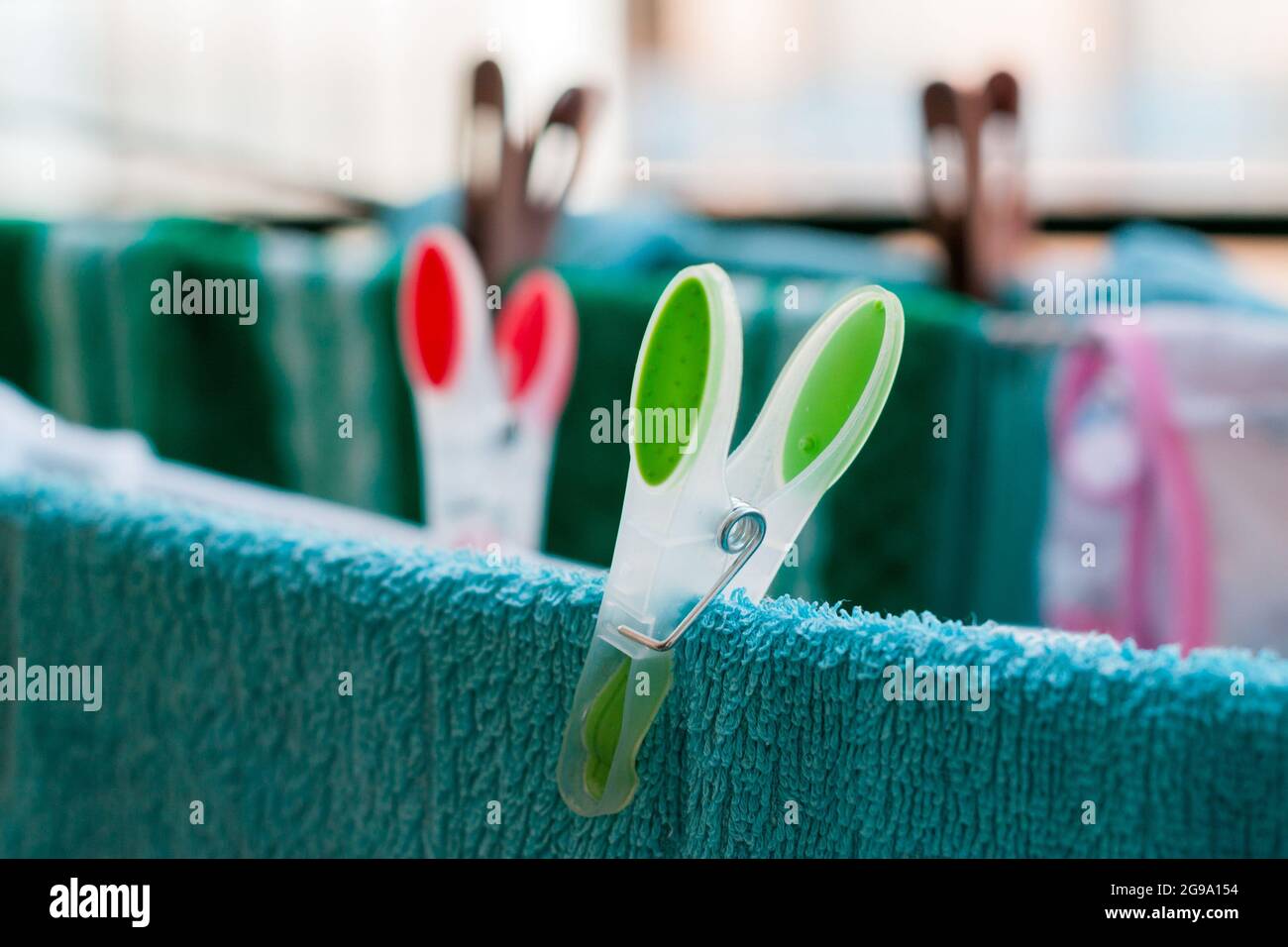 Laundry pins on ropes at home Stock Photo