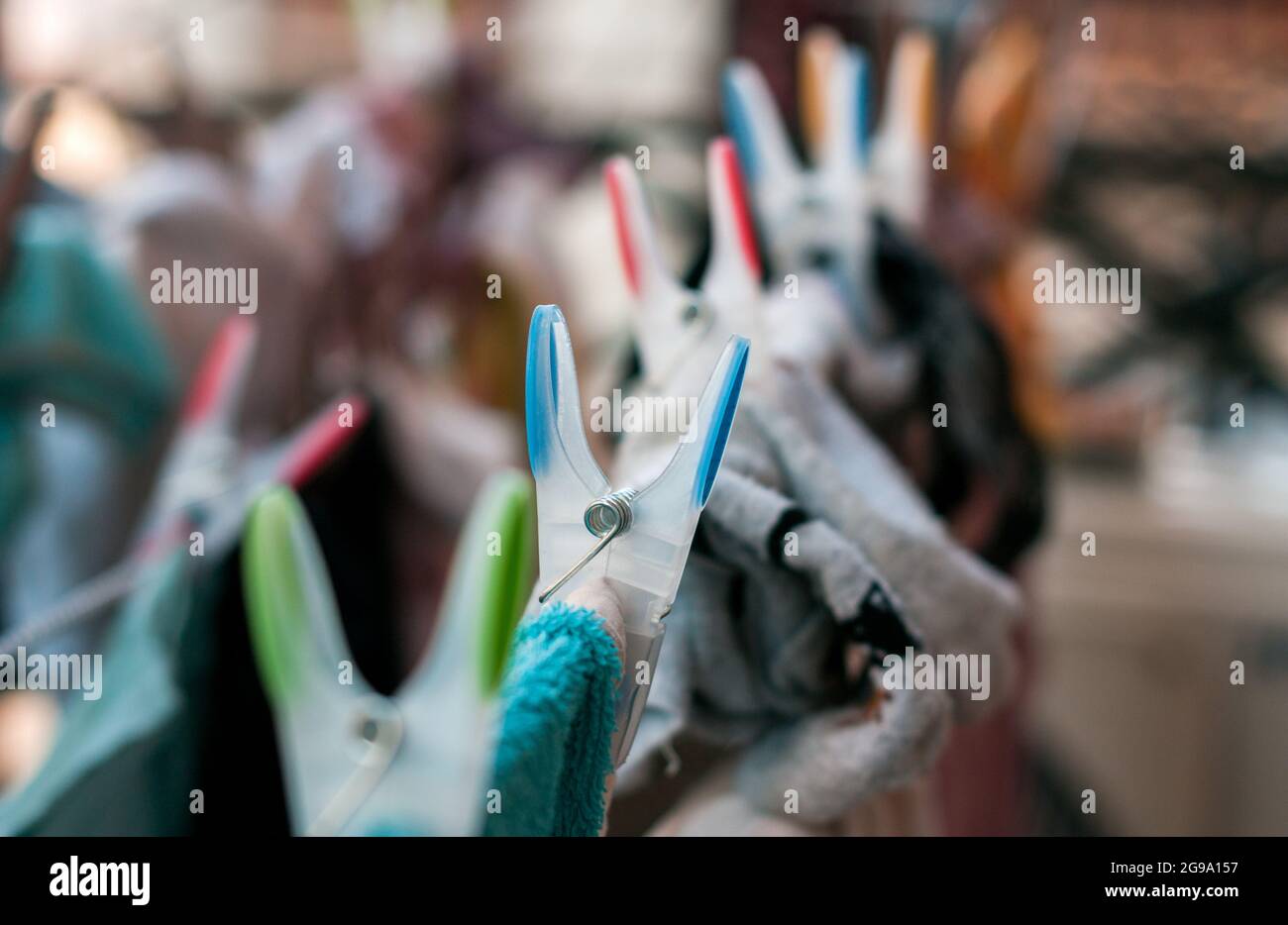 Laundry pins on ropes at home Stock Photo