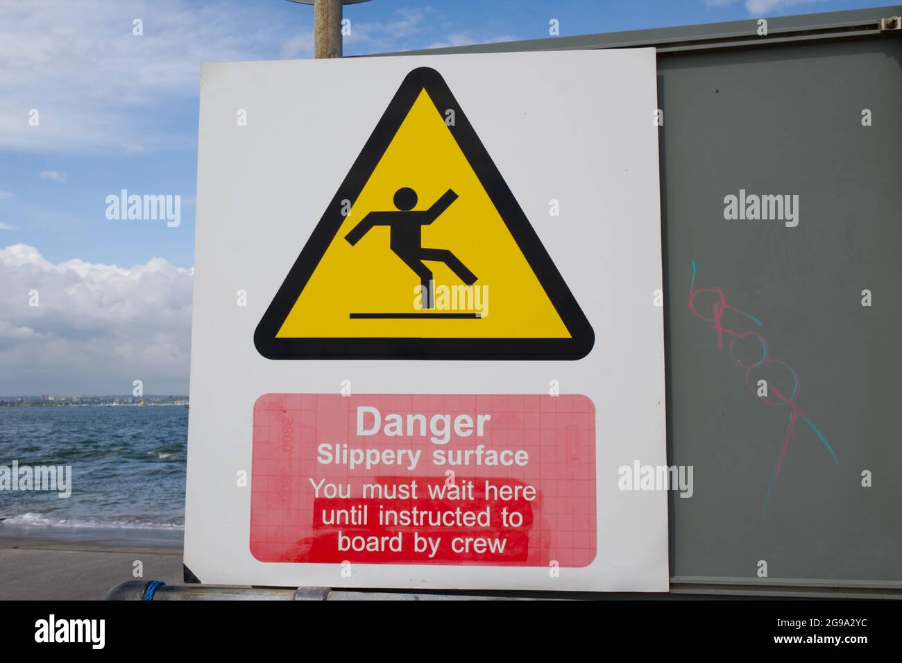 Danger slippery surface sign  Sandbanks to Shell Beach chain ferry Poole Dorset UK Stock Photo