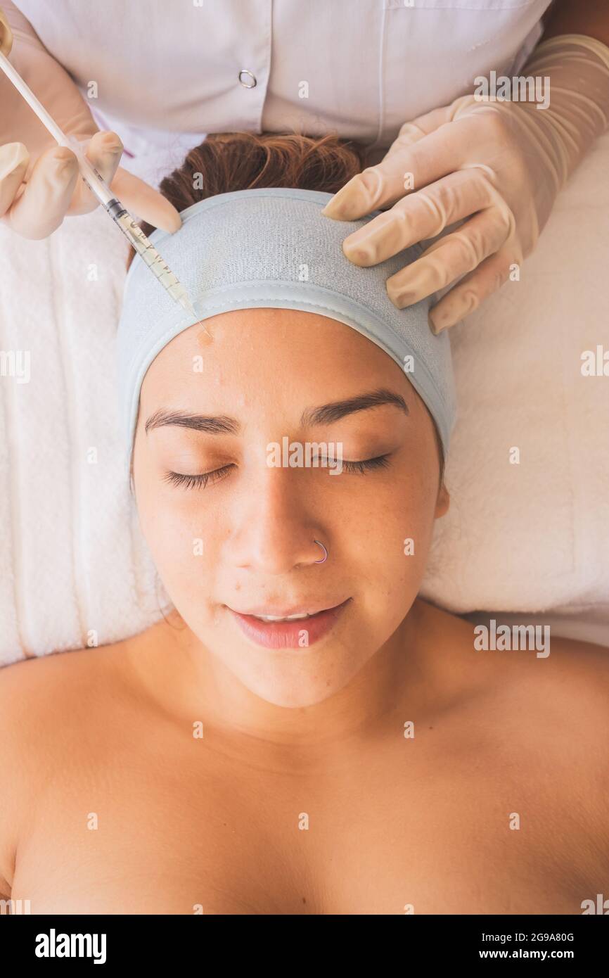 Young Woman Enjoying a Day at the Spa. Performing different treatments for the care of your skin and face. Stock Photo