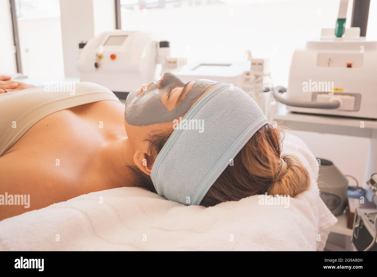 Young Woman Enjoying a Day at the Spa. Performing different treatments for the care of your skin and face. Stock Photo