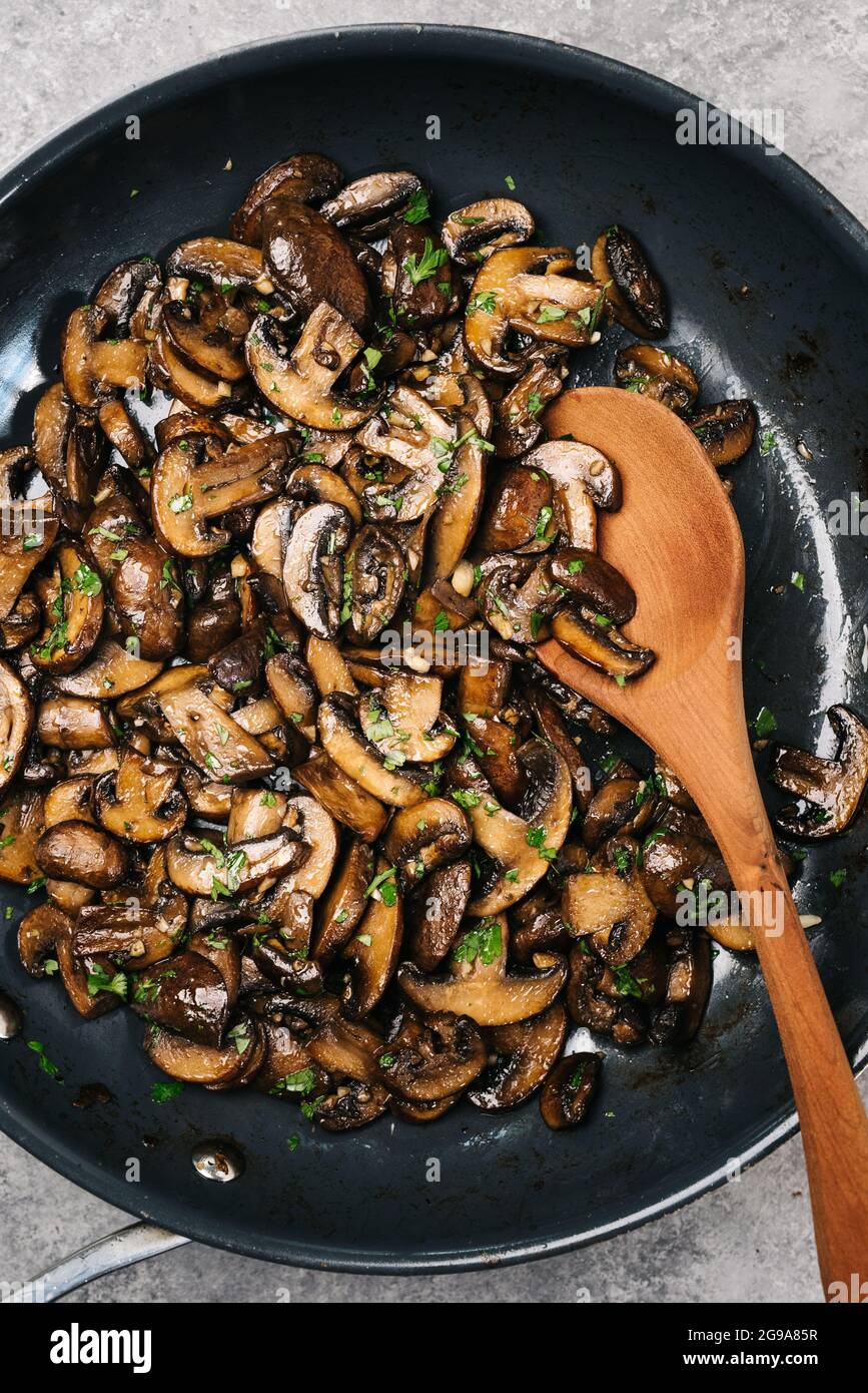 Sauteed Cremini mushrooms in a frying pan Stock Photo Alamy