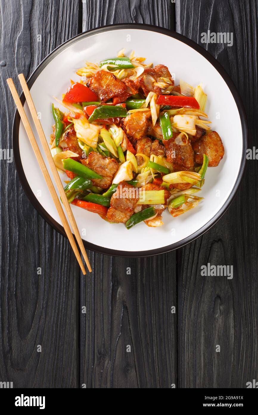 Twice Cooked Pork Or Hui Guo Rou Is A Sichuan Dish Of Spicy Seared Pork Belly Closeup In The Plate On The Wooden Table Vertical Top View From Above Stock Photo