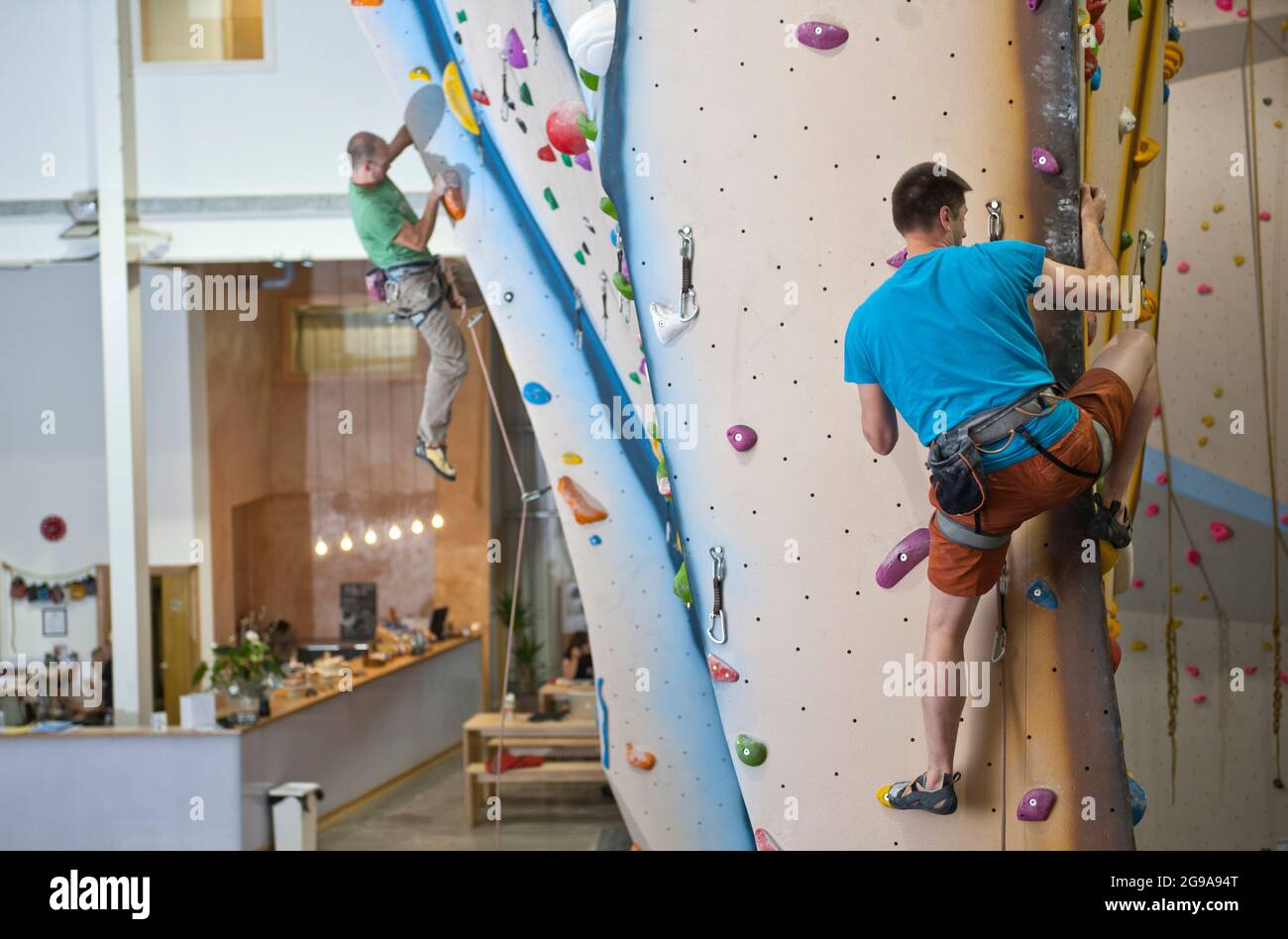 man climbing at indoor climbing wall in London Stock Photo