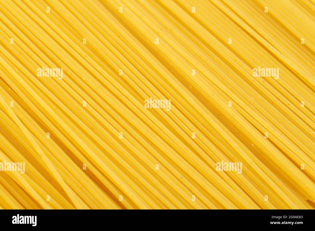 Raw dry spaghetti straight as background. Top view. Design element