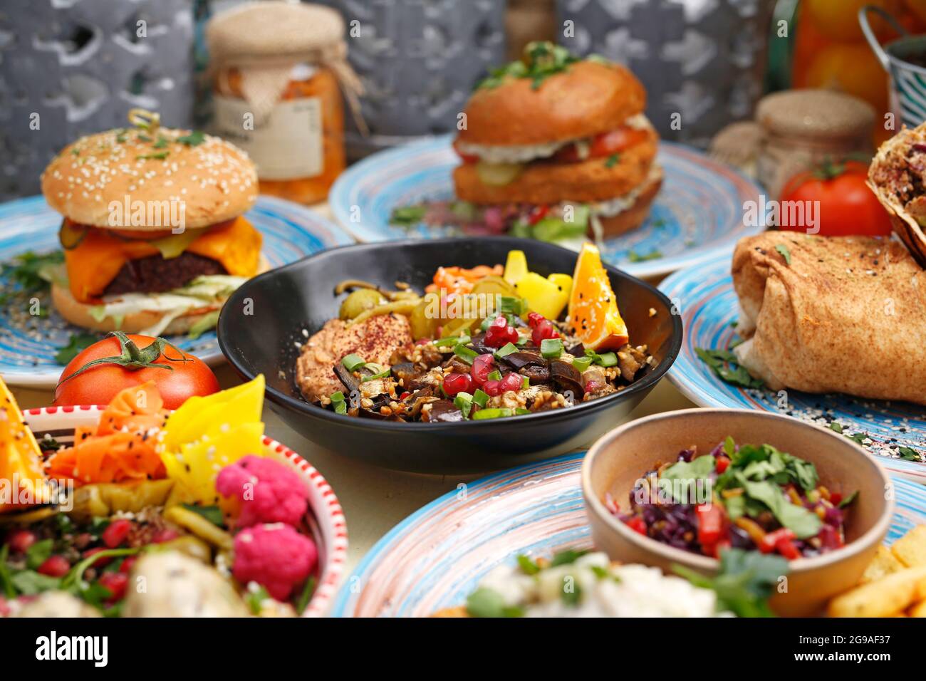 Humus with eggplant and olive salad. Vegetarian cooking. A colorful appetizing dish. Culinary photography, food styling. Stock Photo