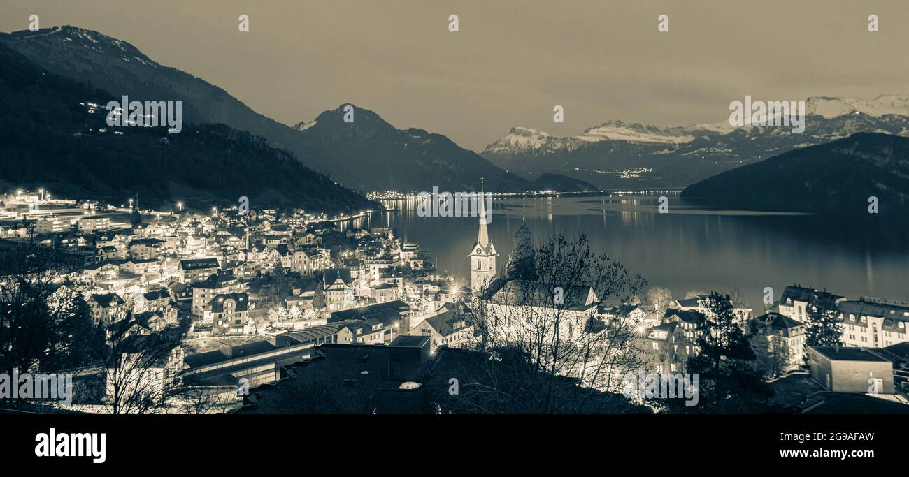 Night panorama. Lights of the city of Weggis. Switzerland. Lake Lucerne.  The peaks of the Alps in the snow. Monochrome. Retro filter Stock Photo -  Alamy