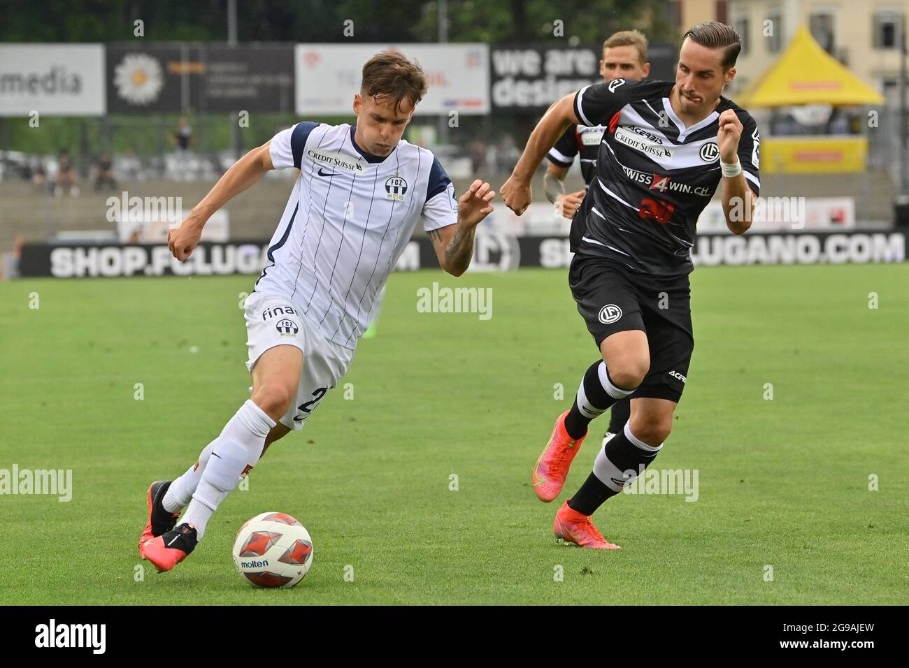 Lugano, Switzerland. 25th July, 2021. Mikael Facchinetti (#7 FC Lugano) and  Nikola Boranijasevic (#19 FC Zuerich) during the Super League match between FC  Lugano and FC Zuerich at Cornaredo Stadium in Lugano