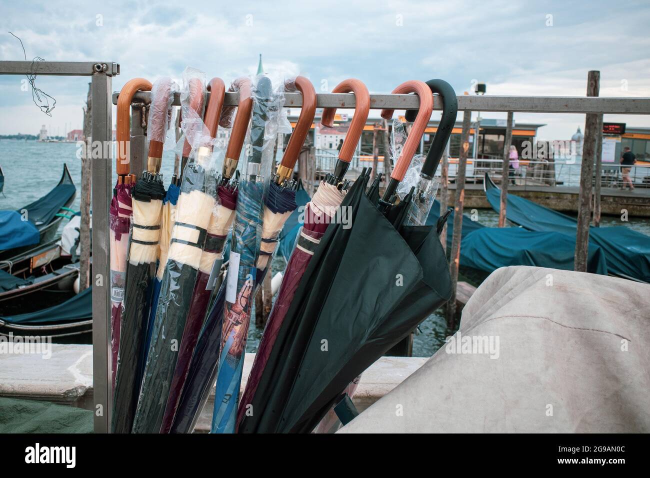 different umbrellas hang side by side on a stand Stock Photo