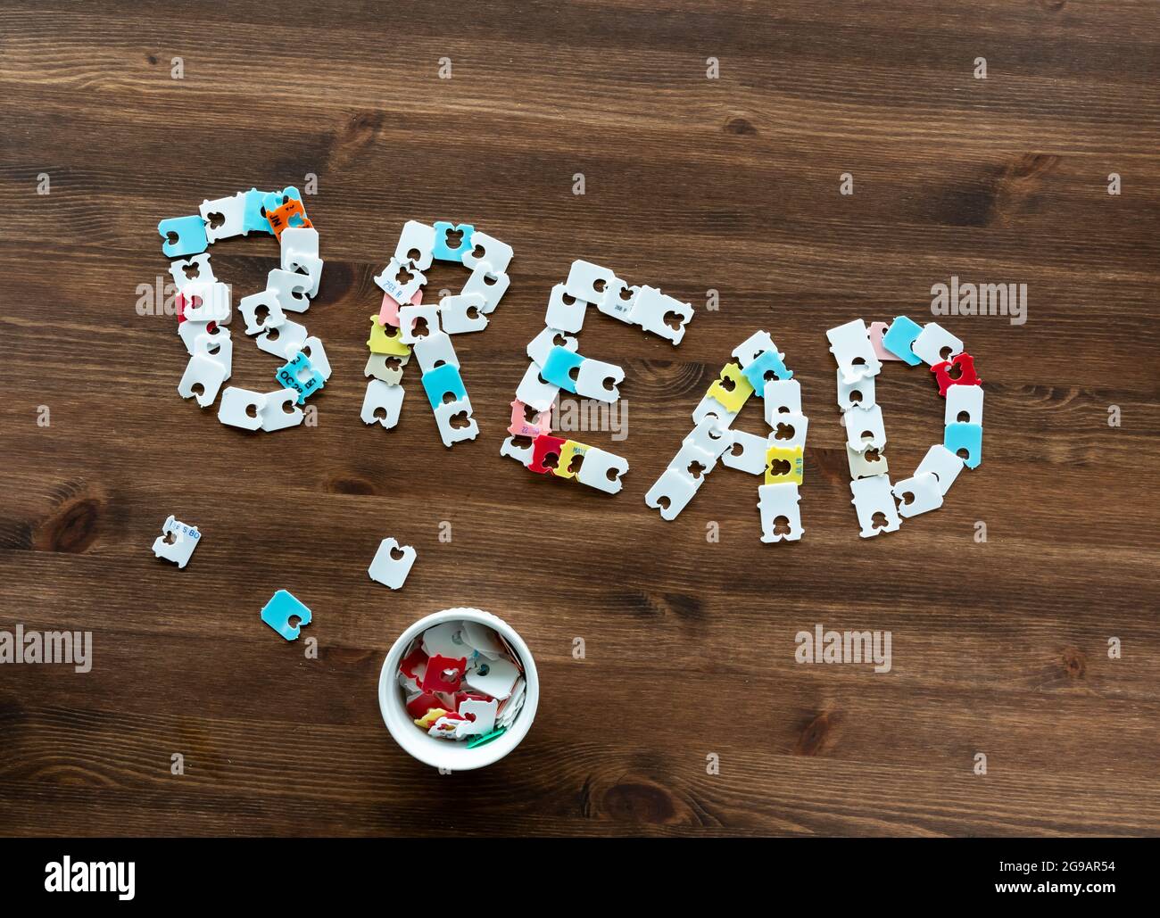 White plastic Bread clips to hold plastic bags closed, for sliced bread.  Also call Bread tags, bread tabs, bread ties or bread-bag clips Stock Photo  - Alamy