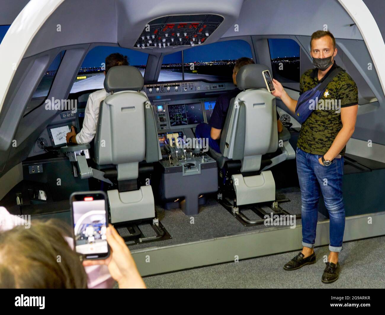 Zhukovsky, Russia. 24th July, 2021. Visitors take pictures of the cockpit  of the flight simulator with their phones.A large-scale program for the  15th MAKS air show was prepared by the aerobatics teams ''