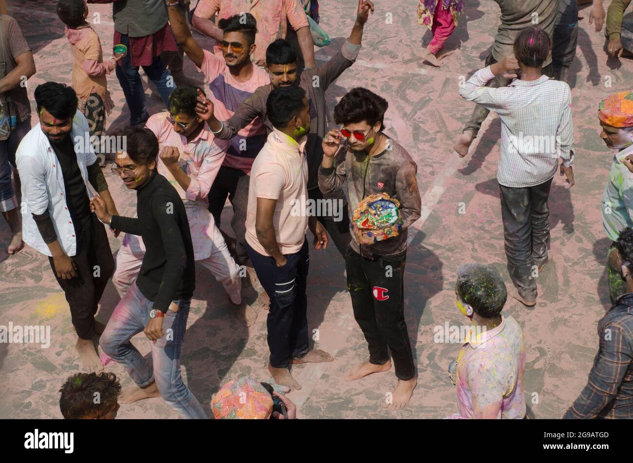 Devotees are dancing celebrating the color festival in India. Stock Photo