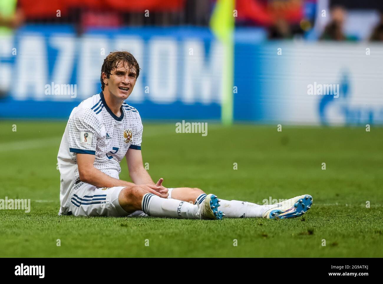 Moscow, Russia - July 1, 2018. Russia national football team defender Mario Fernandes sitting on the pitch having been committed a foul upon during FI Stock Photo
