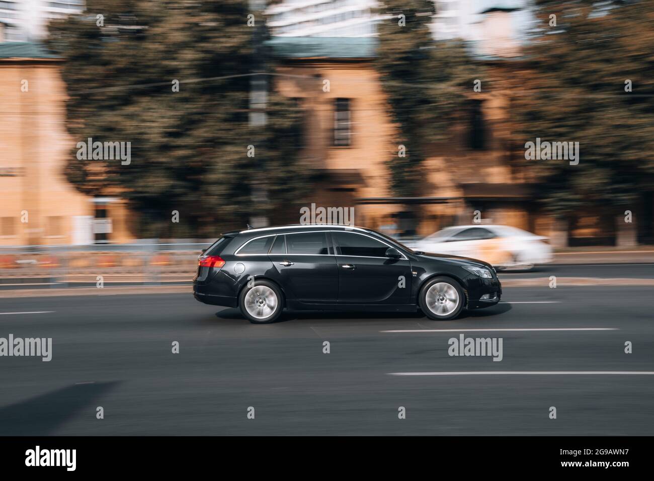 Ukraine, Kyiv - 16 July 2021: Black Opel Insignia car moving on the street. Editorial Stock Photo