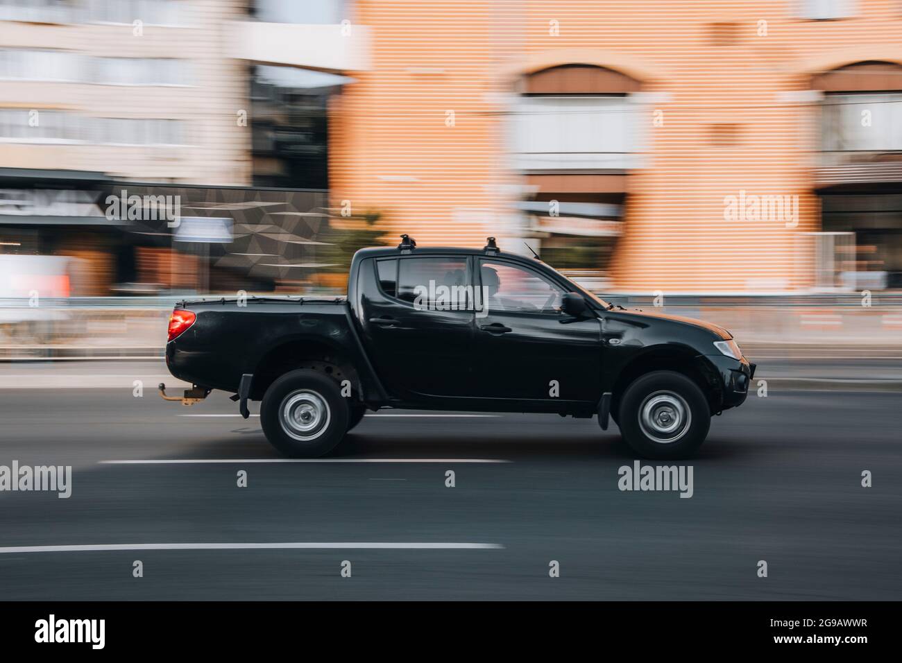 Ukraine, Kyiv - 16 July 2021: Black Mitsubishi L200 car moving on the street. Editorial Stock Photo