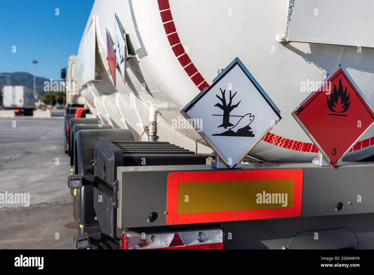 Tank truck with dangerous goods, with labels of flammable and pollutant
