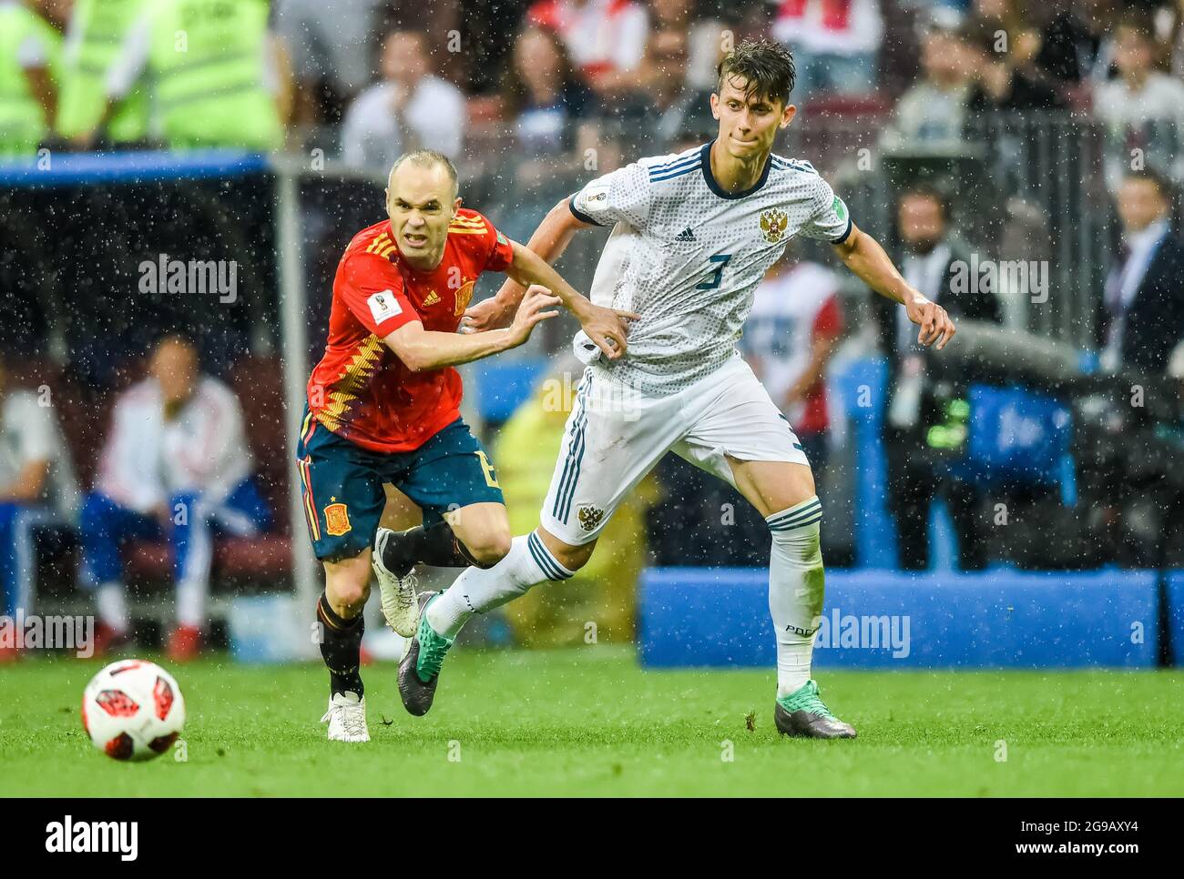 Moscow, Russia - July 1, 2018. Russia national football team defender Ilya Kutepov against Spain midfielder Andres Iniesta, in the pouring rain during Stock Photo