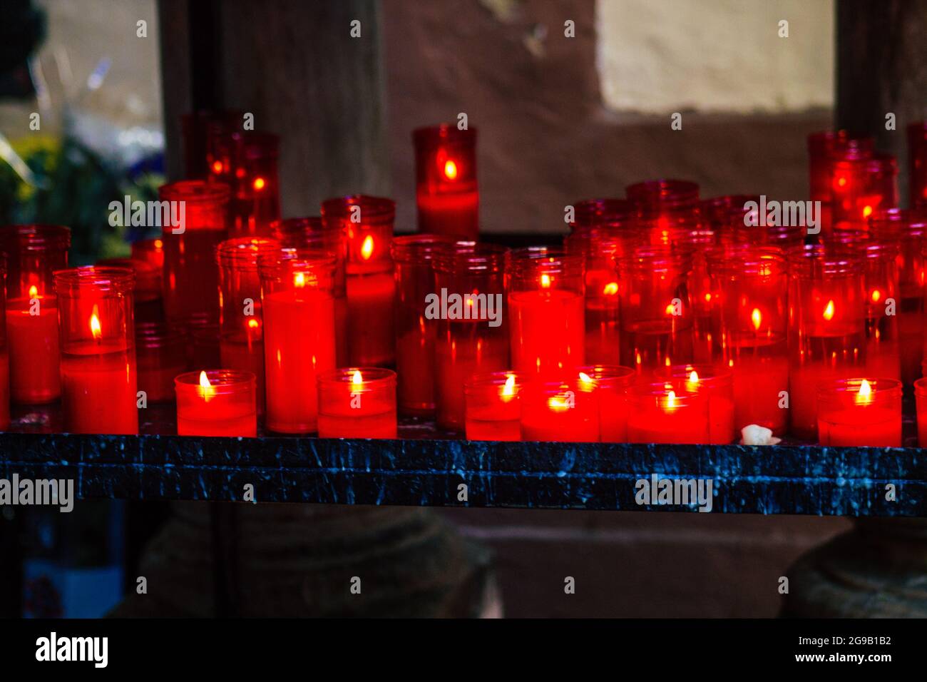 Seville Spain July 23, 2021 Red candles inside a church in Seville