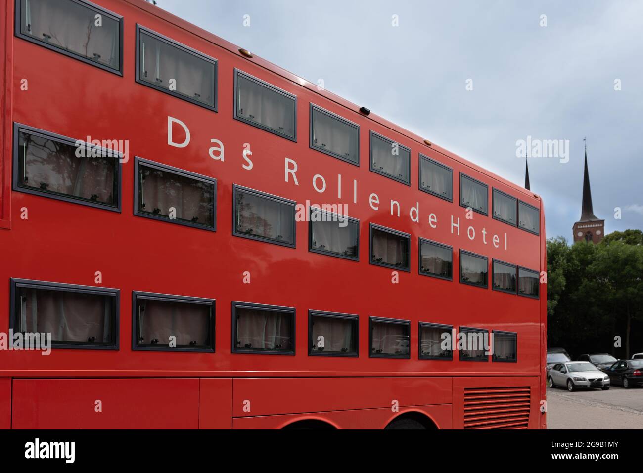 a red triple deck Rotel bus for sleeping guests at the carpark at Roskilde cathedral, Denmark, July 7, 2021 Stock Photo