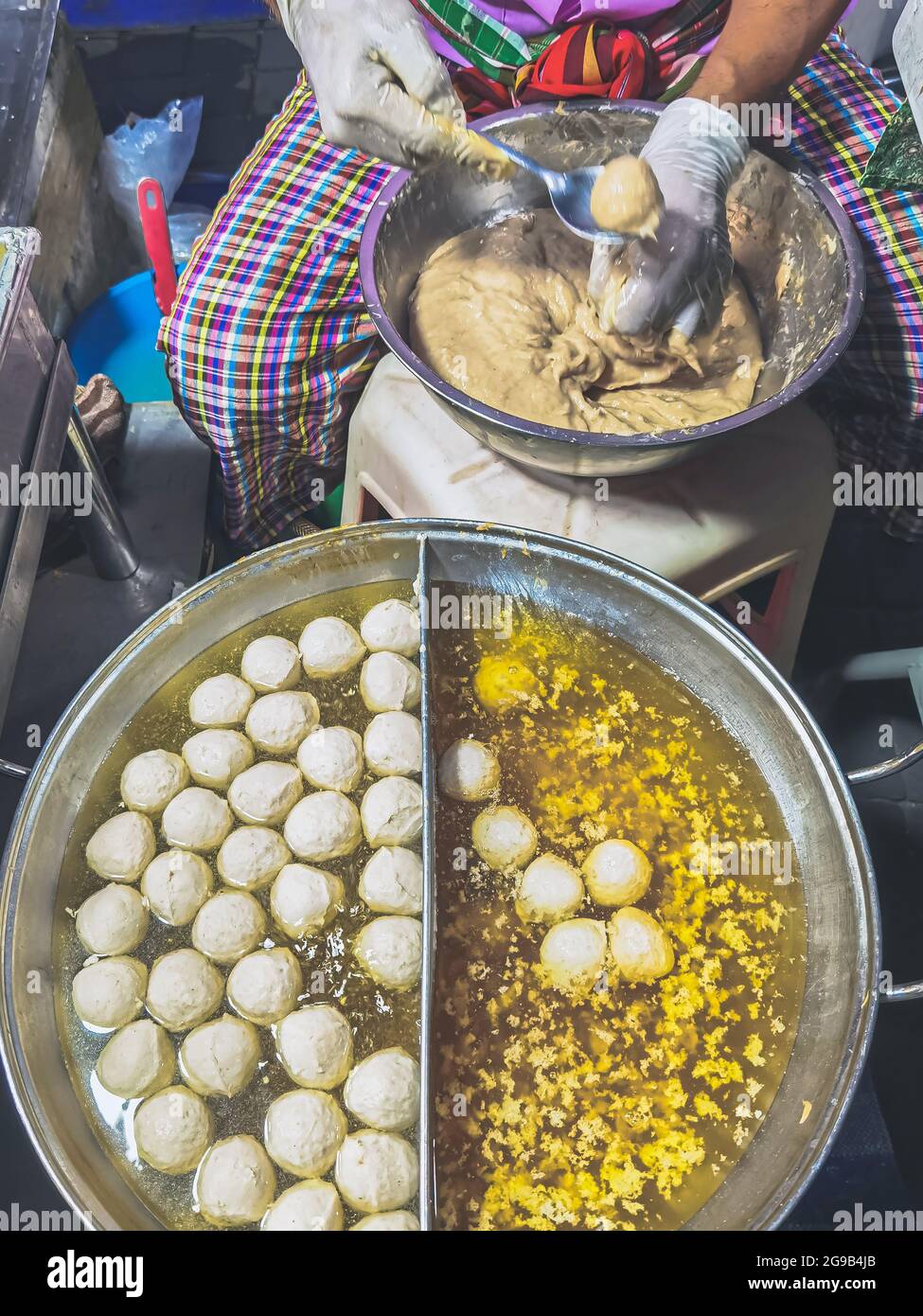 The process of making meatballs in a pan of boiling water. Homemade